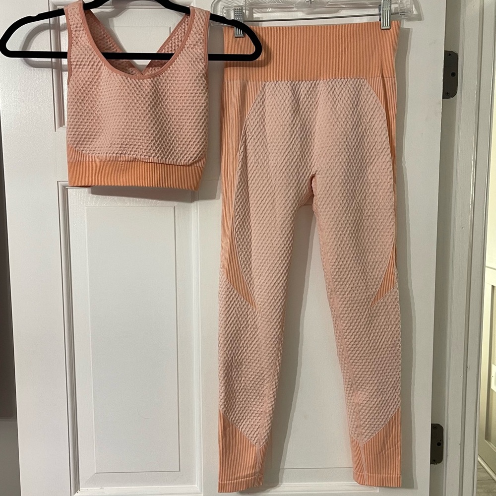 Two-piece workout set. Light peachy two toned. Sports bra/crop top and leggings.